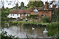 Houses seen across former mill pond beside Mill Lane