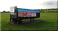 Advertising trailer in a field alongside Leeds Road, Heckmondwike