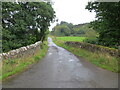 Minor road and bridge crossing a small burn near to Milnholm