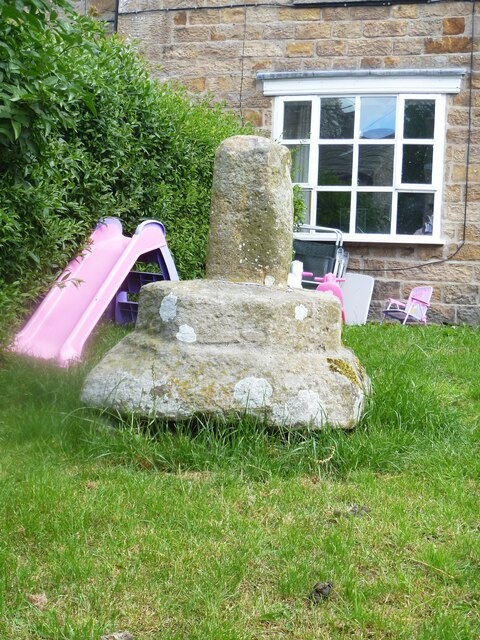 Bowes features [3] In the garden of Cross House on The Street &lt;a href=&quot;https://www.geograph.org.uk/photo/7333162&quot;&gt;NY9913 : Bowes houses [5]&lt;/a&gt; is this base and stump of a cross shaft. Medieval, of sandstone. Listed, grade II, with details at: &lt;span class=&quot;nowrap&quot;&gt;&lt;a title=&quot;https://historicengland.org.uk/listing/the-list/list-entry/1159719&quot; rel=&quot;nofollow ugc noopener&quot; href=&quot;https://historicengland.org.uk/listing/the-list/list-entry/1159719&quot;&gt;Link&lt;/a&gt;&lt;img style=&quot;margin-left:2px;&quot; alt=&quot;External link&quot; title=&quot;External link - shift click to open in new window&quot; src=&quot;https://s1.geograph.org.uk/img/external.png&quot; width=&quot;10&quot; height=&quot;10&quot;/&gt;&lt;/span&gt;
Bowes is a village in County Durham, some 14 miles northwest of Richmond and about 18½ miles due west of Darlington. Set on the north bank of the River Greta, the village was, until by-passed, astride the A66 trunk road. The Romans had a fort here, guarding the Stainmore pass over the Pennines, and their site was reused by the Normans who built a castle. The village grew around the castle, and the name Bowes is first mentioned in a charter of 1148.