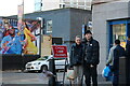 People and a pigeon outside Lidl, Finsbury Park