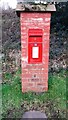 NY5054 : EIIR post box with benchmark at bottom near crossroads south of Faugh by Roger Templeman
