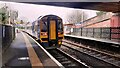 A Class 158 diesel multiple unit leaves Burley Park Station on a service to York