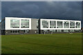 Stone Lodge School, against a very stormy sky