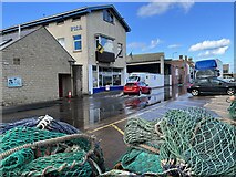 NT9464 : High Tide Floods Harbour Road at Eyemouth by Jennifer Petrie