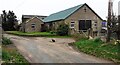 Farm buildings and a cat at Easby Farm