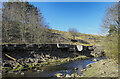 Eroding river bank with industrial remains