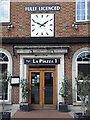 Restaurant entrance with a large clock