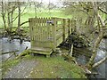 Gated wooden footbridge over the Afon Iwrch