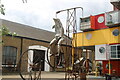 View of a dolphin riding a penny farthing sculpture on Trinity Buoy Wharf