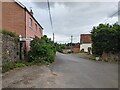 Signpost and houses in Adsborough