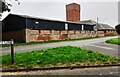 Farm buildings and water tower on north side of Stainby Road (B676)