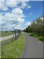 NCN568 by fence of solar farm, Deeside Industrial Estate