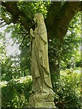 SE2126 : Mourner statue in the old graveyard of St Peter's Church, Birstall by Humphrey Bolton