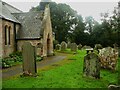 NZ0461 : Porch and gravestones, St Peter's Church, Bywell by Humphrey Bolton
