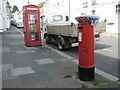 A pillar box with a hat