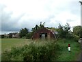 Old Nissen hut on farmland, Wicken