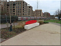 TQ2189 : Bench in Colindale Park, tube train beyond by David Hawgood