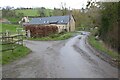 SO6133 : Country road passing a barn conversion by Philip Halling