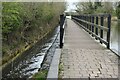 Towpath bridge across overflow weir