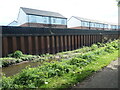 Flood wall below houses in Newtown Green