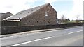 Barn conversion on south side of A596 at Low Whinnow Farm