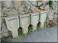 A quartet of empty utility markers on Ffordd Penmynydd, Llanfairpwllgwyngyll