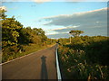 Straight road pointing south-east up Stan Hill