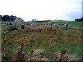 Stone circle and distant view of the Prop of Ythsie.