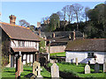 Dunster Priory churchyard, old house and view to Castle