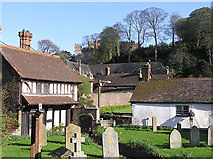 SS9943 : Dunster Priory churchyard, old house and view to Castle by Martin Southwood