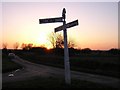 Cast iron signpost by sunset.