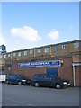 Blue cars, blue sign, blue sky