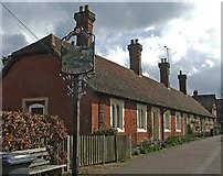 TL4218 : Almshouses, High Street, Much Hadham, with village sign. by Christine Matthews