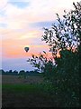 Balloon drifting into the sunset