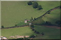 Deserted barn or house at road junction