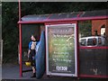 A kayaker stood at the bus stop