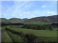 Farmland with woods and hills