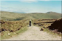 V5461 : Lone Motorcyclist, Croom Road, Cahernageeha Mountain by Martin Creek