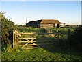 A Wooden Gate And Barn