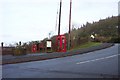 Postbox, notice board and phonebox by the B4293 at Itton Common.