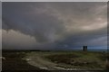 NZ7309 : Danby Beacon with wall cloud by Colin Grice
