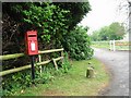 TR2742 : Post box and entrance to St Radigund's Abbey Farm by Nick Smith