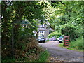 Lasgarn Cottage and footpath sign to Lasgarn Wood