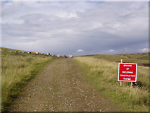 SD8318 : Rossendale Way crossing wind farm access road by Mike Lee