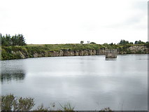 NO8696 : Water filled quarry by George Wilson