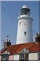 Lighthouse over house tops