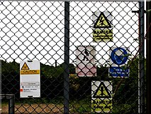 TL1780 : Signs on gate to mobile telephone mast buildings by Andrew Tatlow