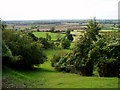 View down steep ridge to farmland