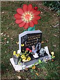 SK9772 : Gravestone and adornments, Newport Cemetery, Lincoln by Dave Hitchborne